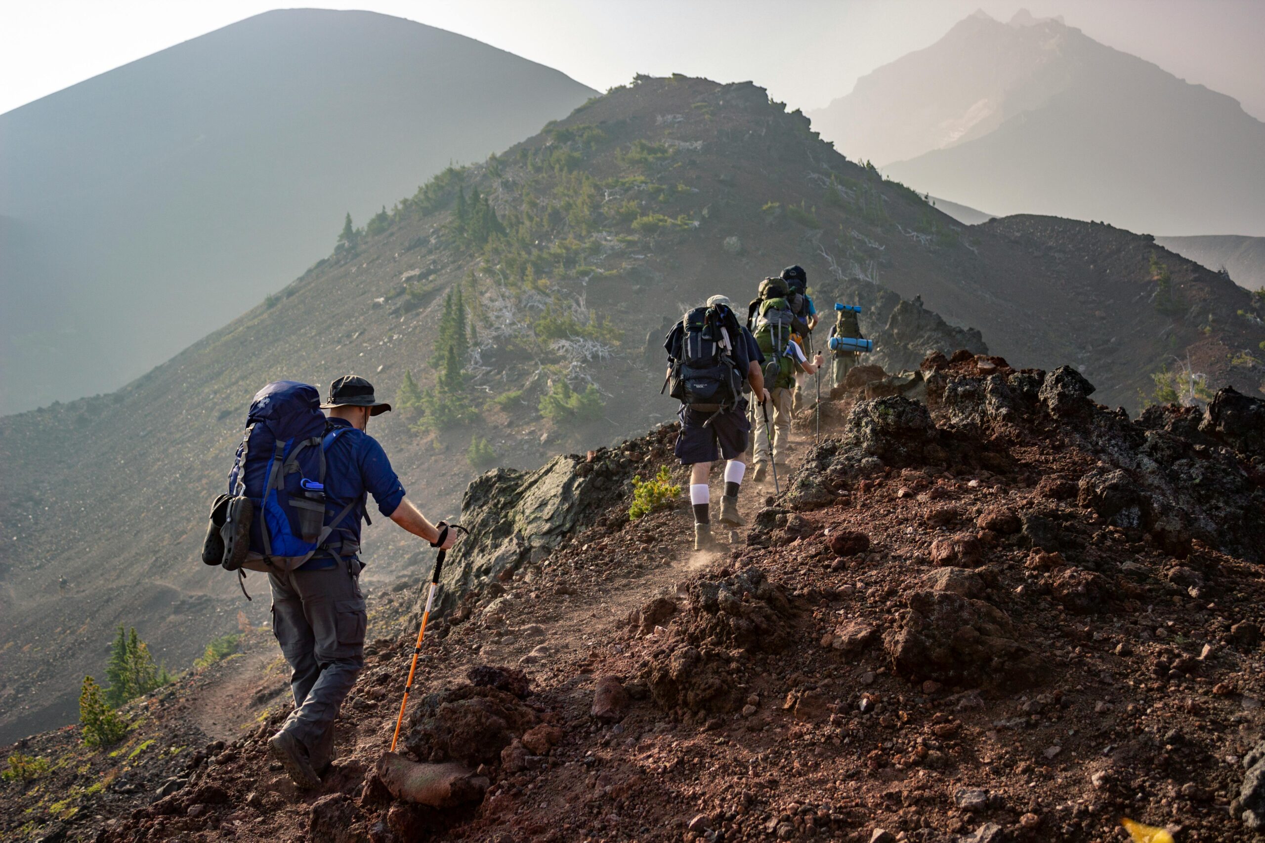 Group of hikers trekking on a rugged mountain trail in Oregon